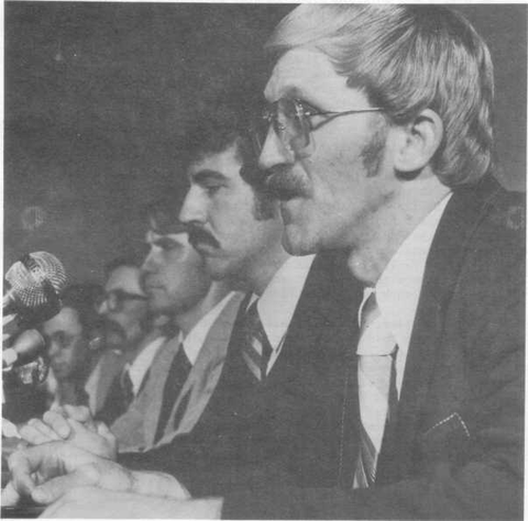 Five men seated at a hearing table, photographed for the 1979 Three Mile Island report